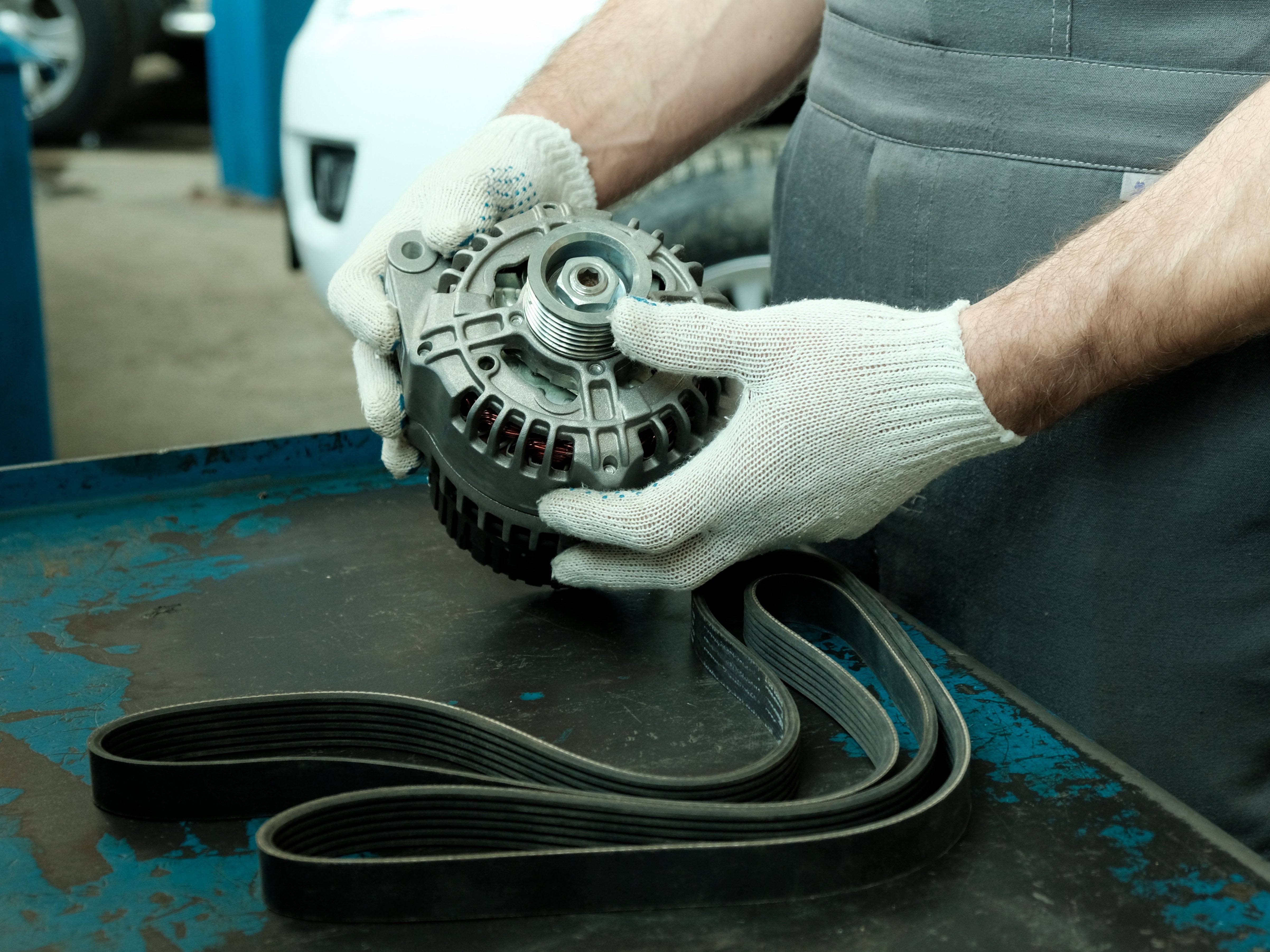 Hands with Glove holding an alternator Devils Lake, ND